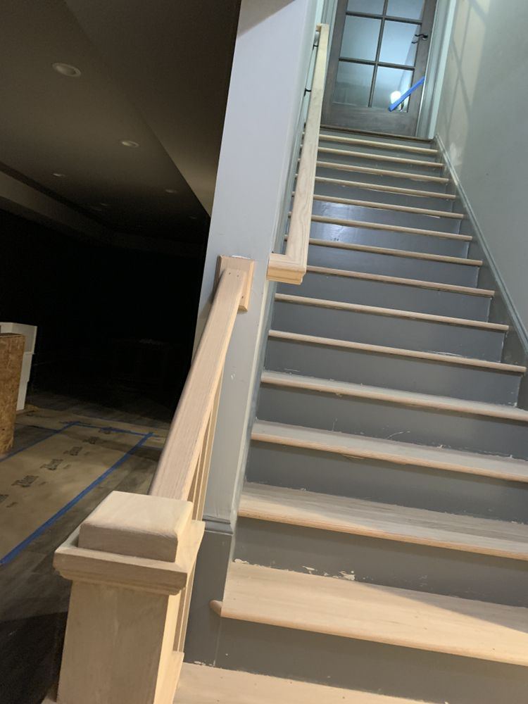 Basement stairs with new raw oak treads, newel post and handrail