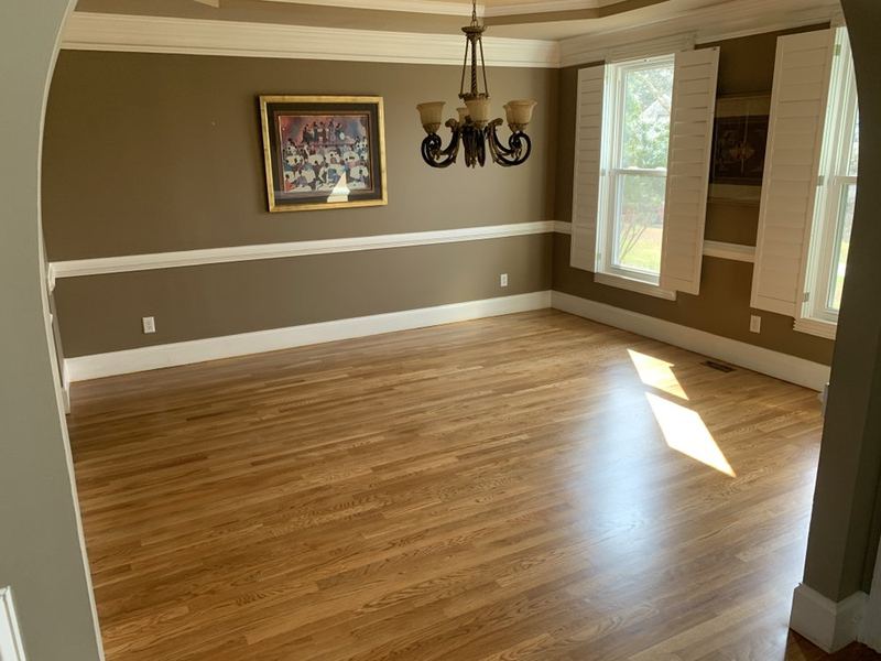 Dining room with plantation shutters and a natural oak floor