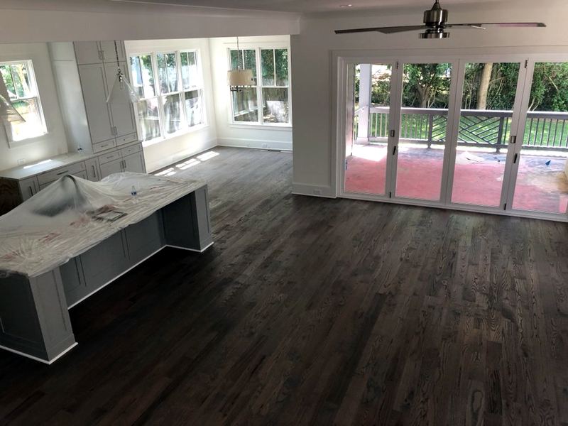 New-construction kitchen and living area with a dark stained oak floor