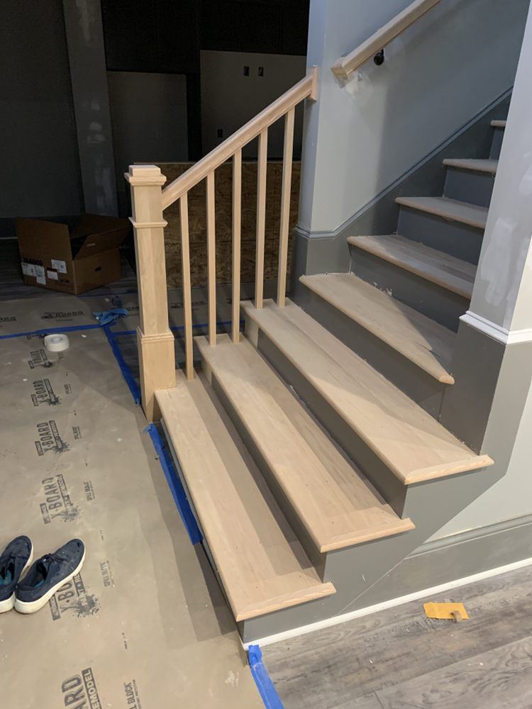 Newly installed raw oak stair treads, newel post and balusters