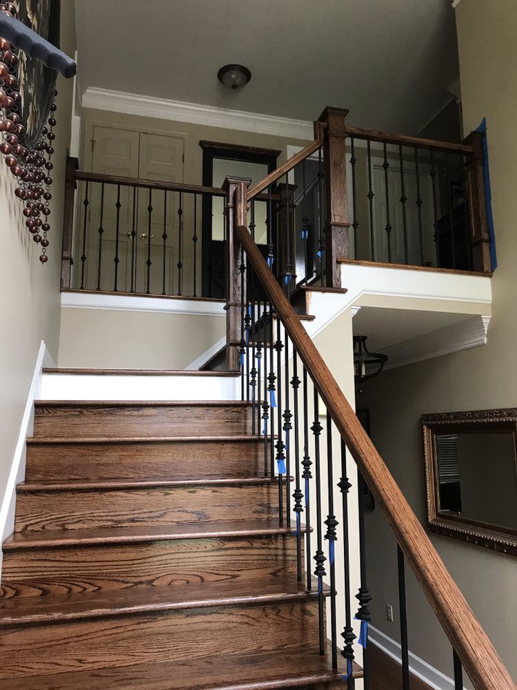 Staircase with brown stained oak treads, handrail and iron spindles
